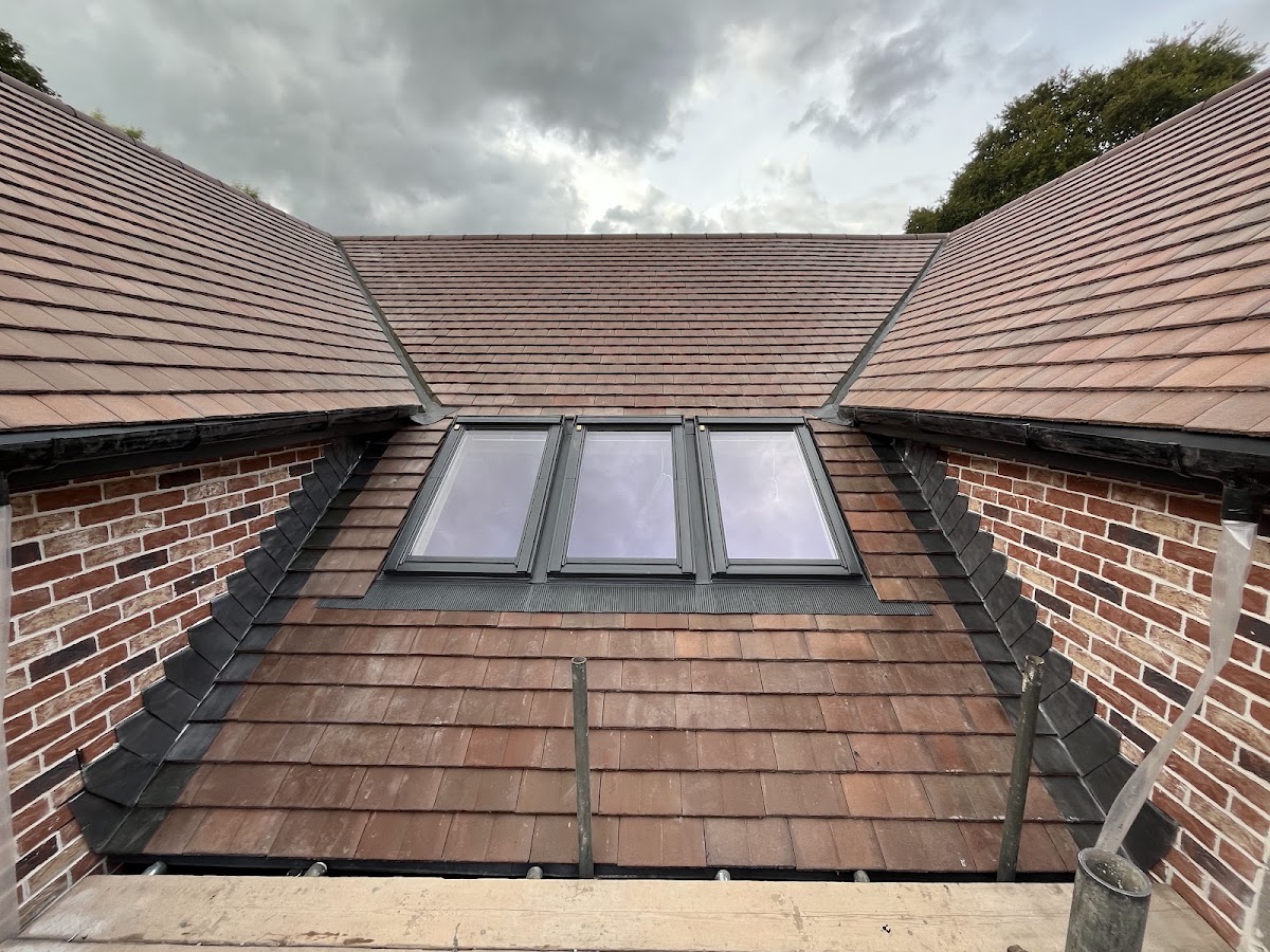 A finished tiled roof with roof windows by Chandler Roofing Services